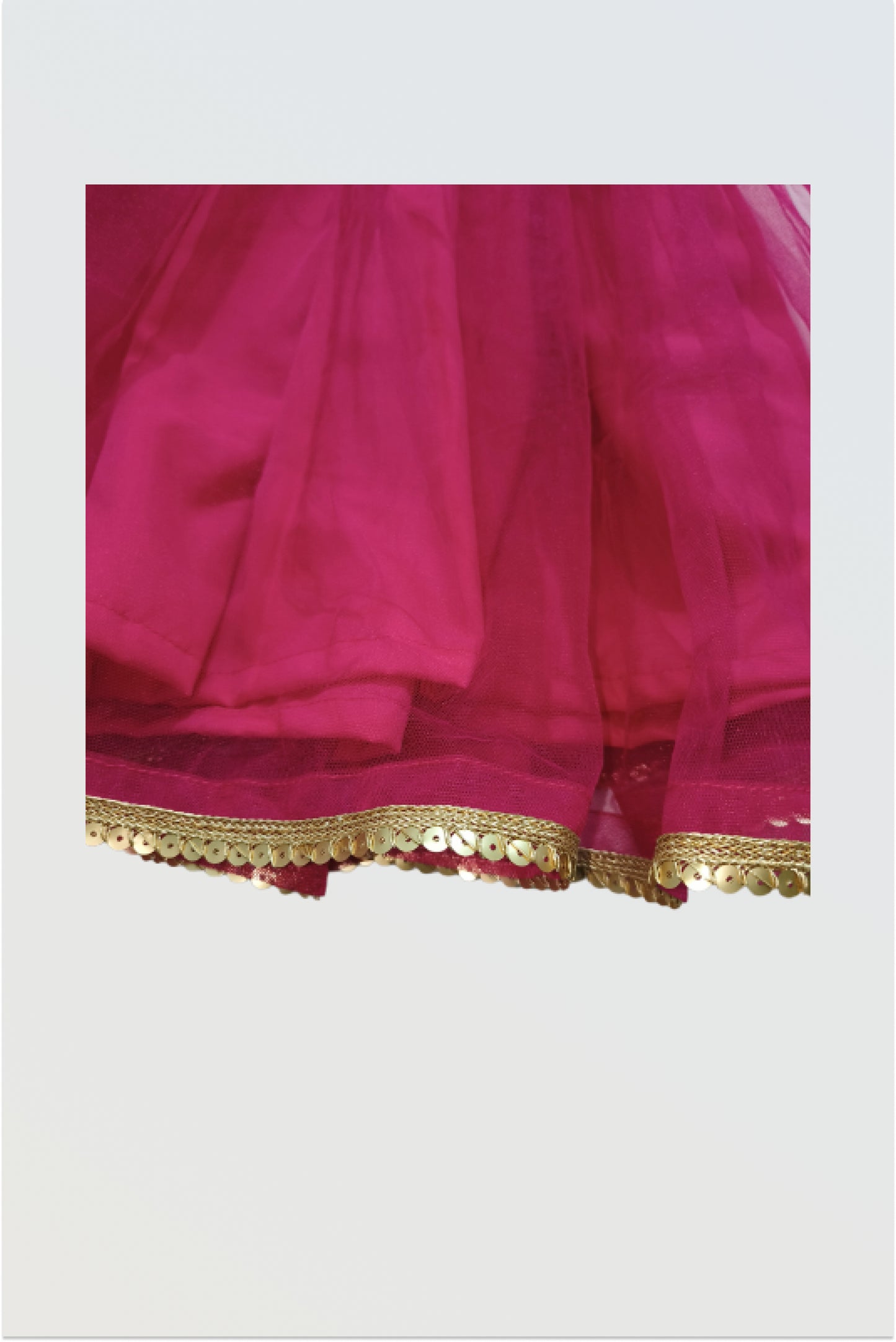 Close up showing brocade fabric texture and net lehanga material detail