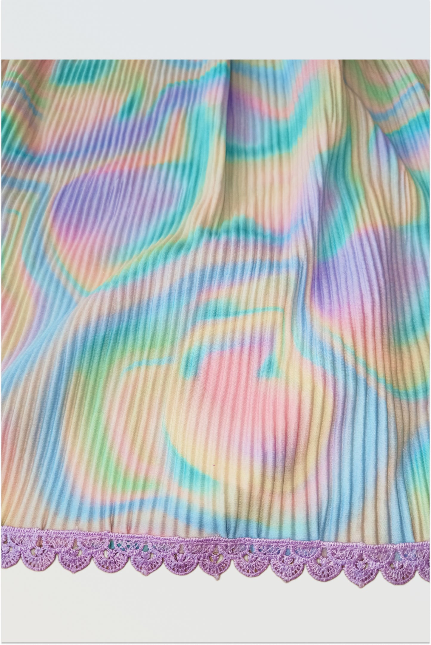 Close up of hakoba cotton fabric showing traditional textured weave pattern colourful holi lehanga