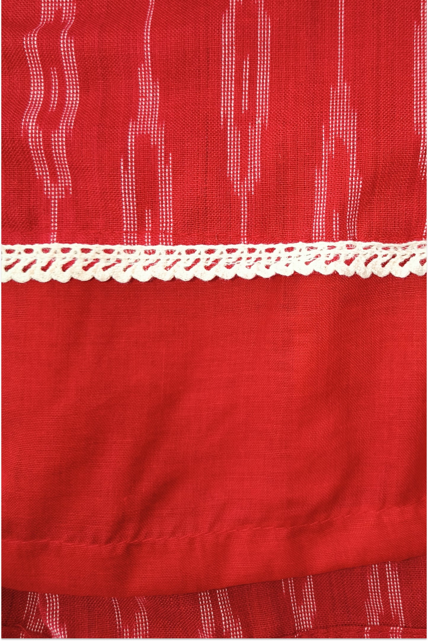 Detailed view of ikat cotton weave texture in purple and red traditional design
