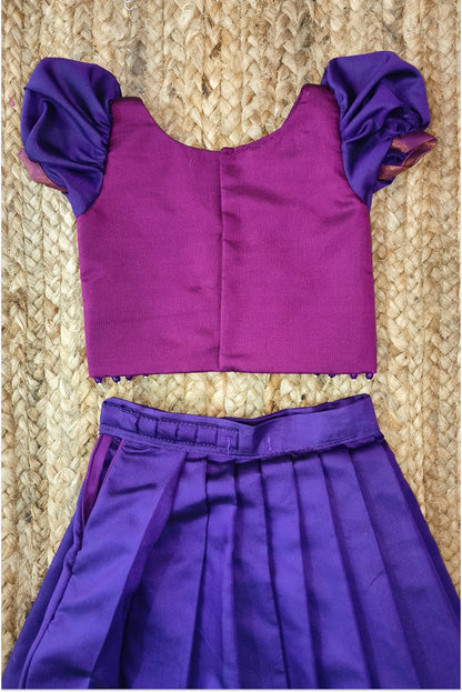 Magenta choli with golden embroidery and purple puffed sleeves - close-up detail