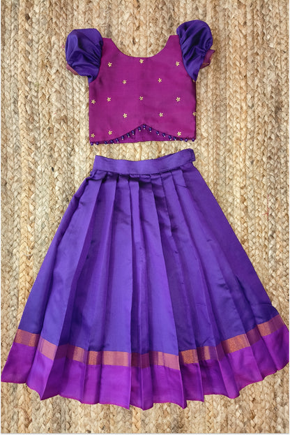 Purple pleated lehanga with golden zari border and magenta band - back view