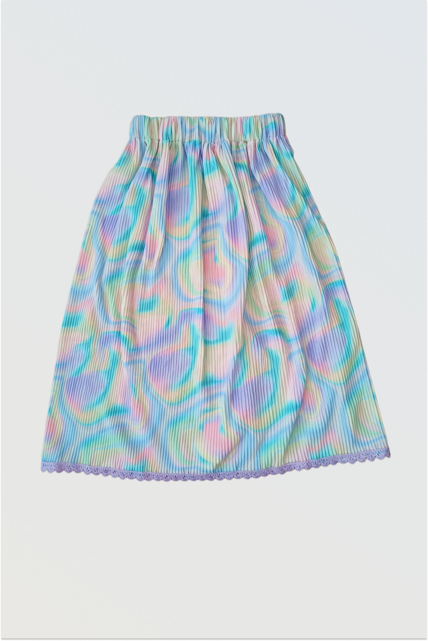 Accordion pleated colourful holi lehanga skirt showing permanent pleats and crocheted lace hem