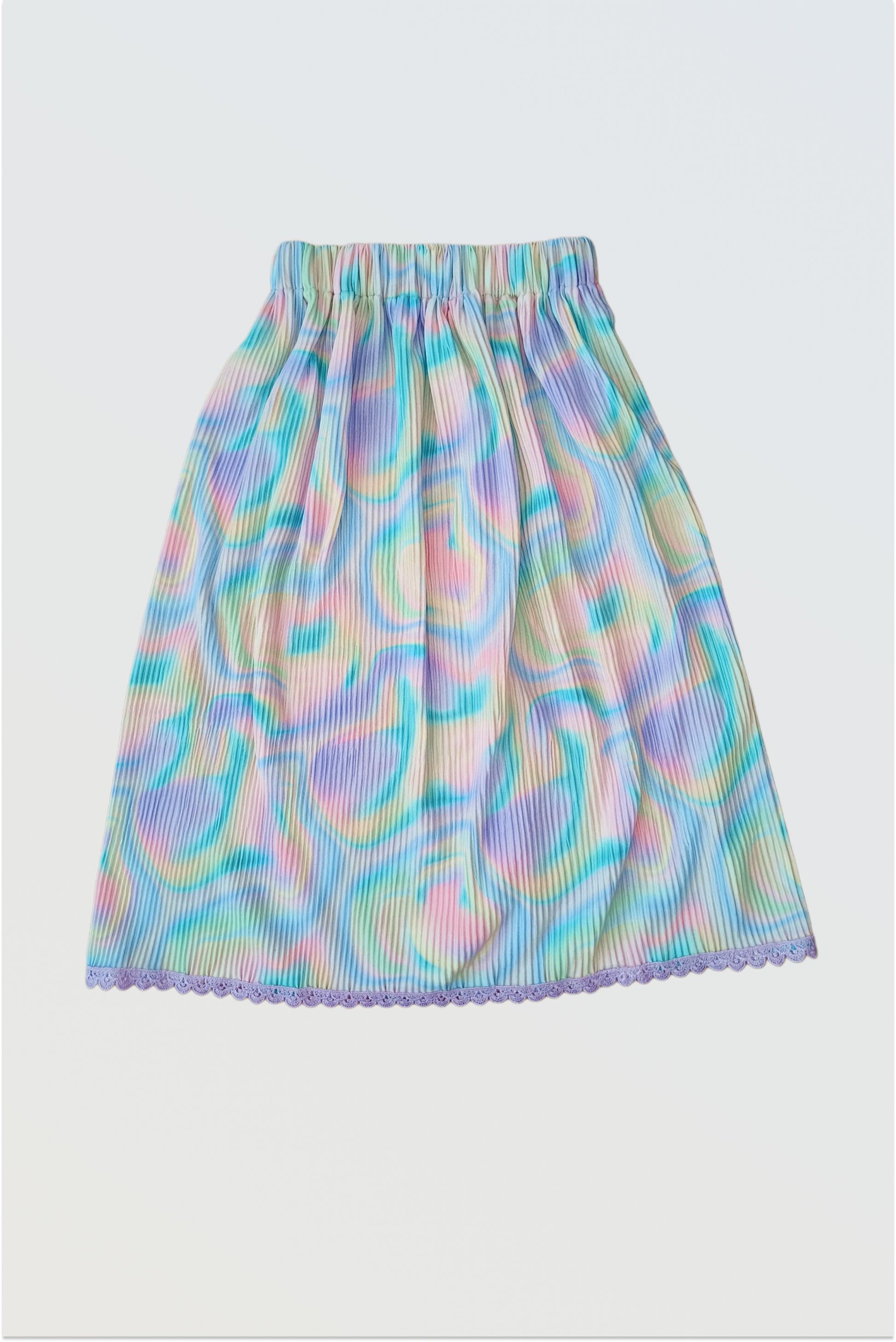 Accordion pleated colourful holi lehanga skirt showing permanent pleats and crocheted lace hem