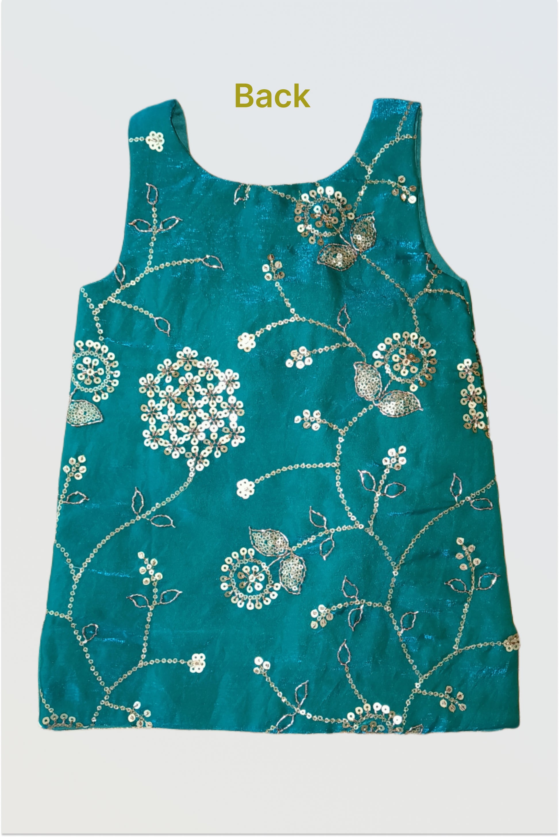 Close up of all-over sequin embellishment on peacock green space silk fabric