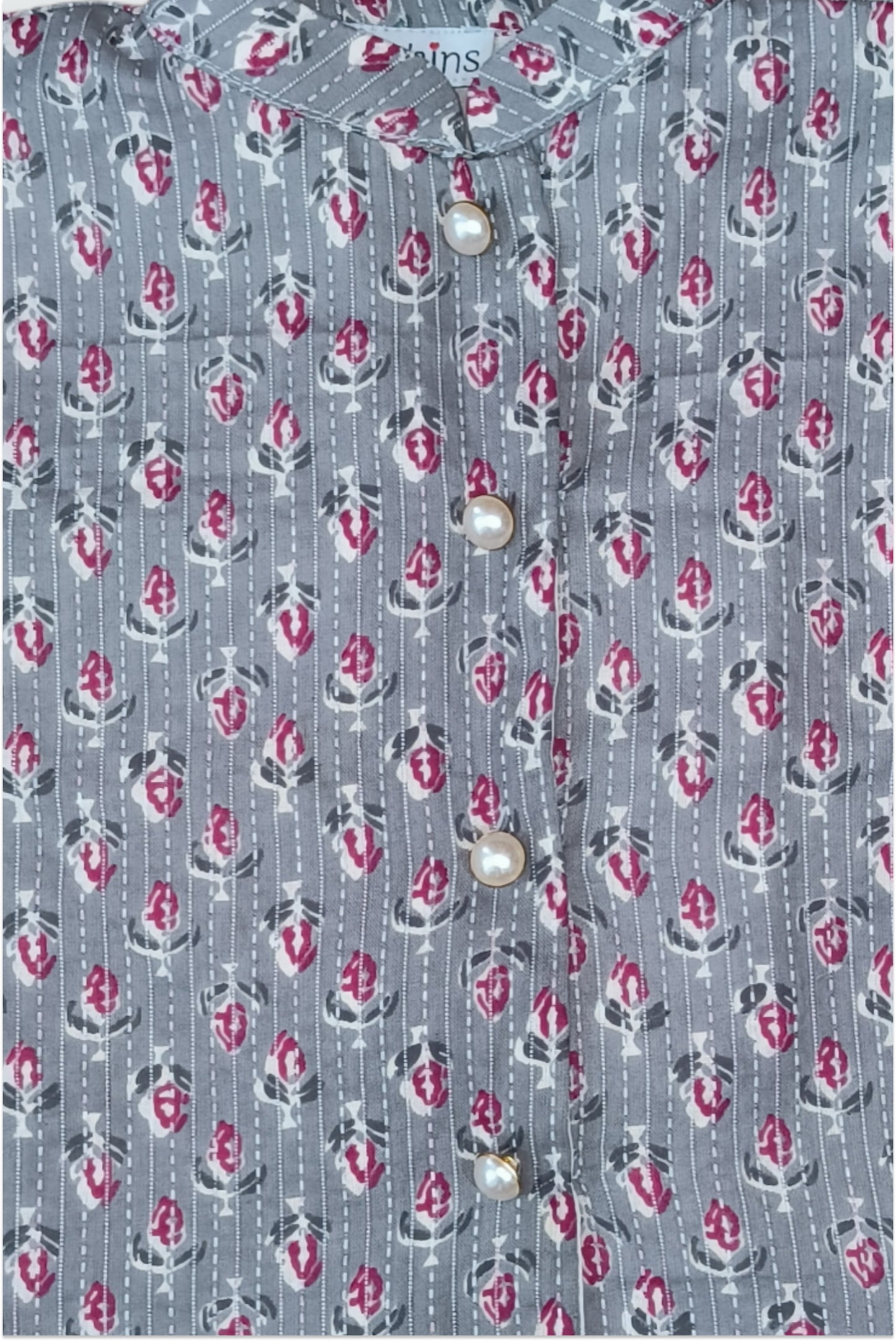 Close up of grey block printed fabric with traditional kantha running stitch embroidery