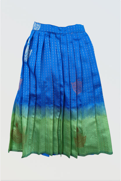 Close up of blue green peacock-inspired art silk fabric showing luxurious color and texture