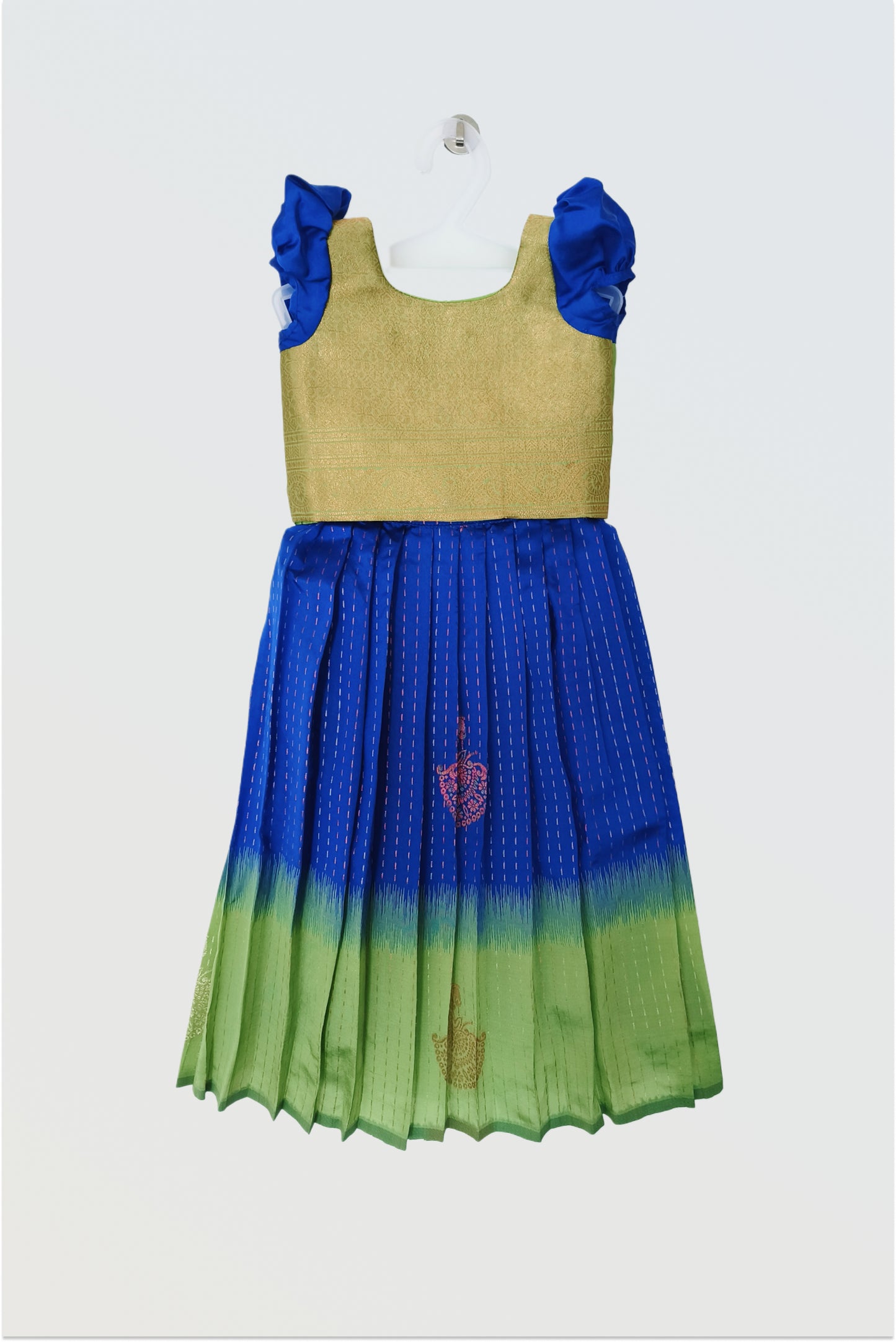 Blue green art silk pattu pavadai flat lay showing short sleeved blouse and traditional skirt"