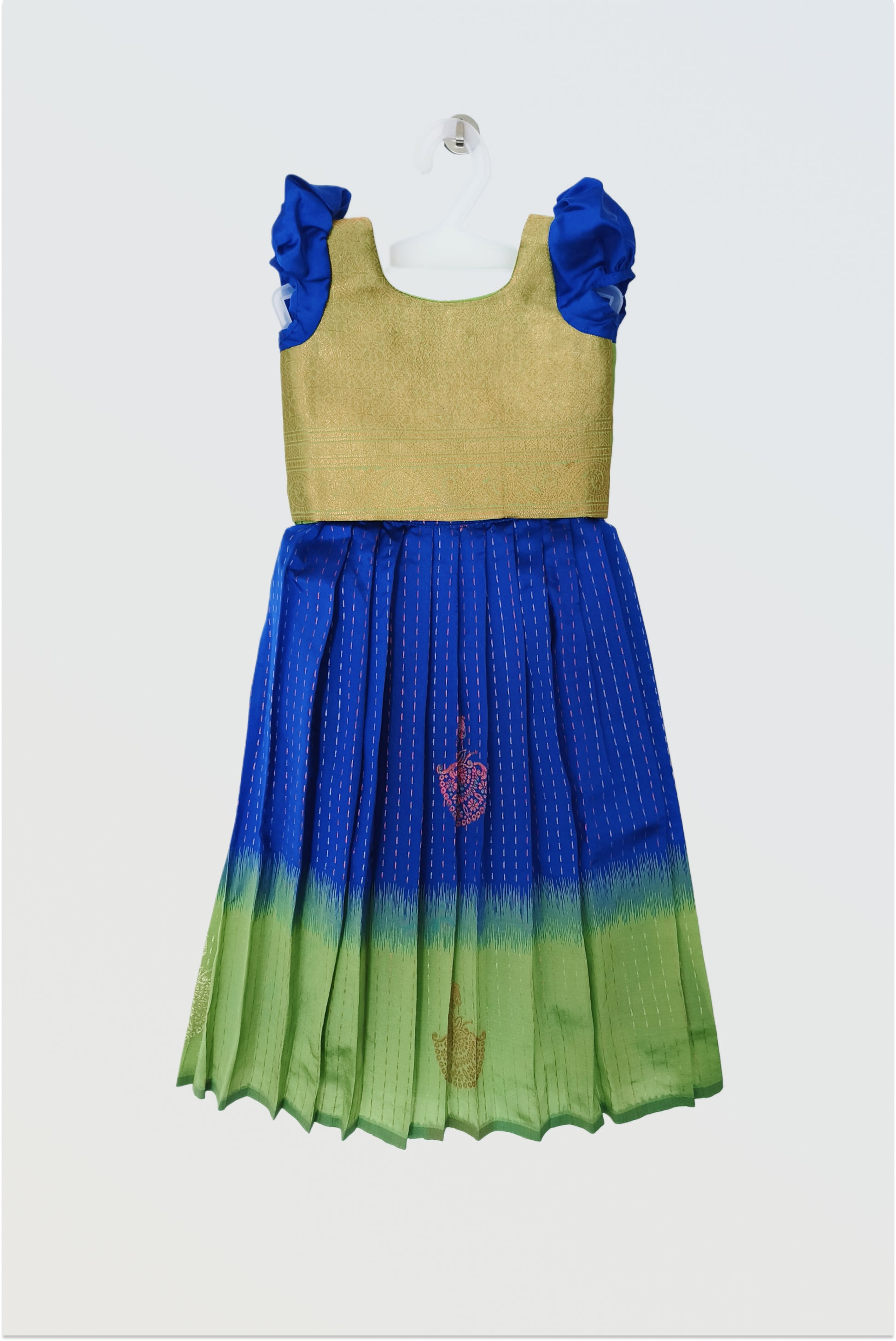 Blue green art silk pattu pavadai flat lay showing short sleeved blouse and traditional skirt"