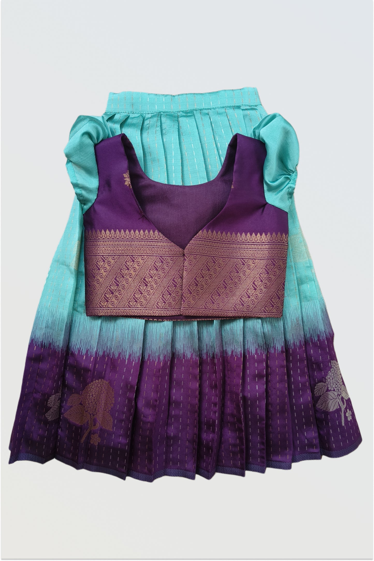 Blue purple art silk pattu pavadai flat lay showing short sleeved blouse and traditional skirt