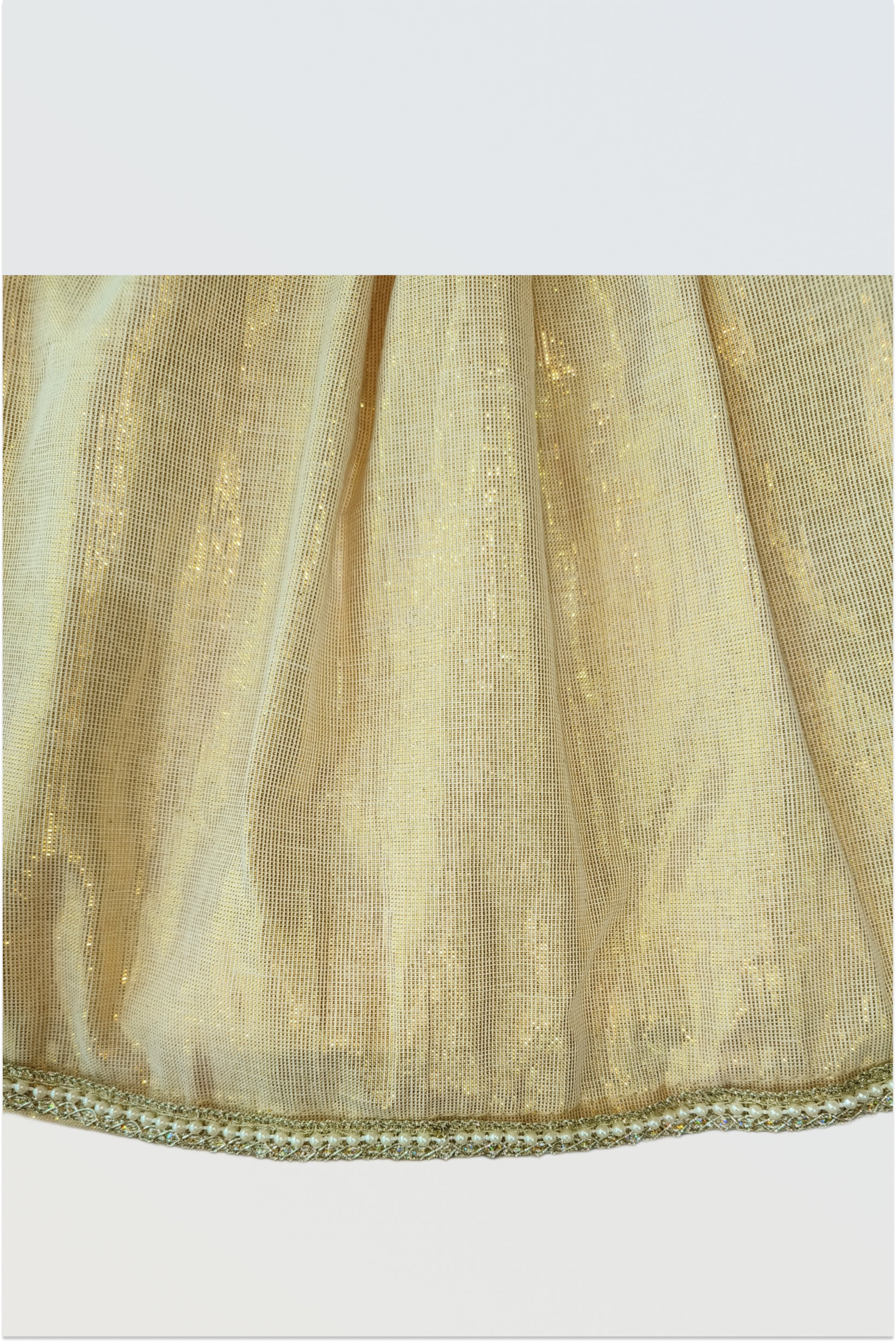 Close up of brocade fabric showing traditional paisley motif pattern and woven texture