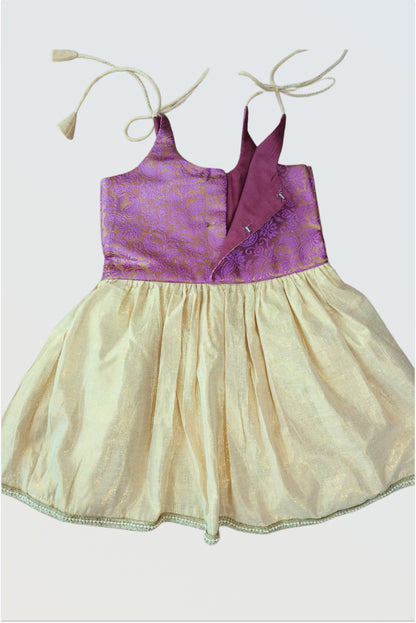 Back view of brocade tie-up frock showing adjustable shoulder straps and lace hem detail