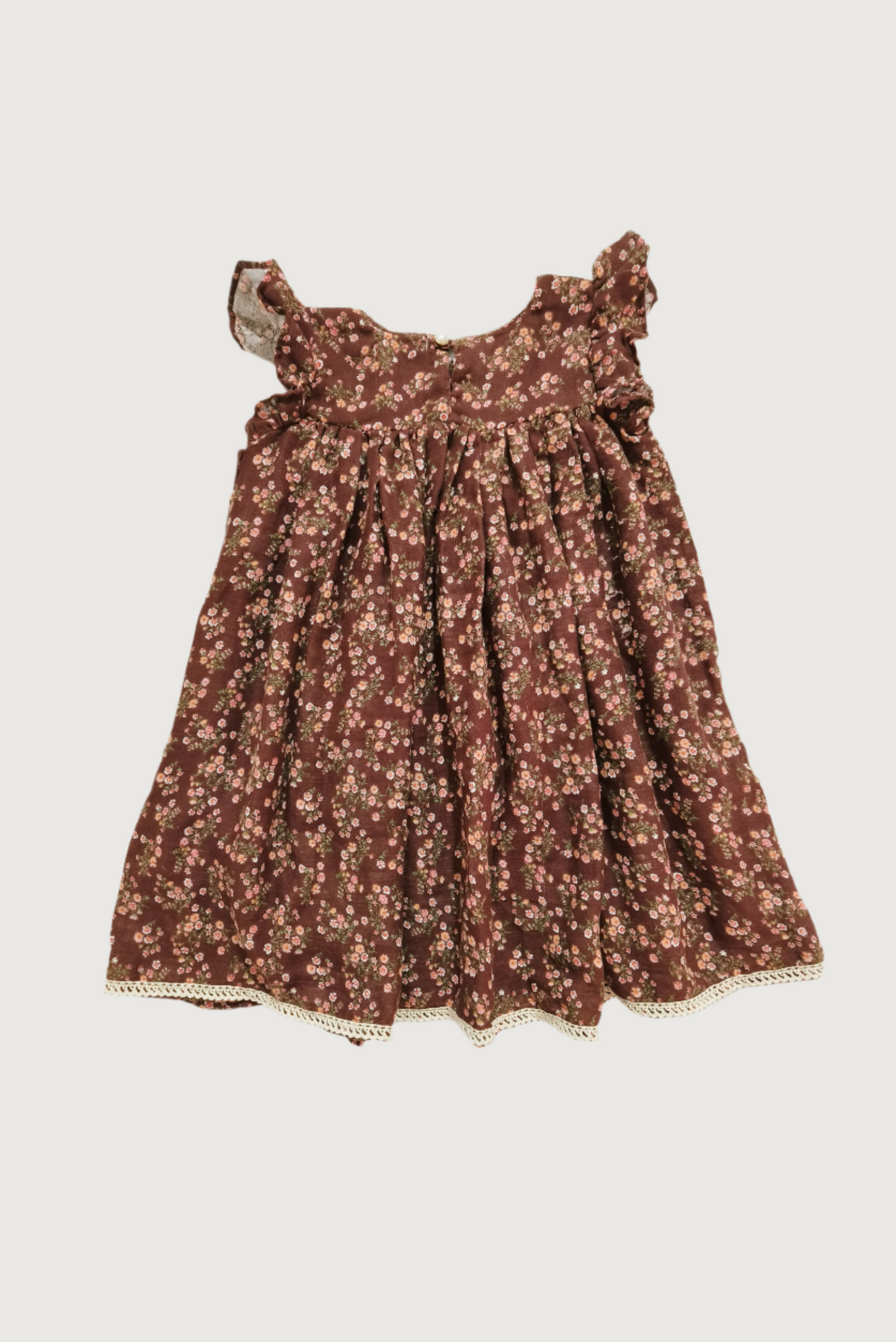 Back view of brown floral dress showing button closure and overall silhouette