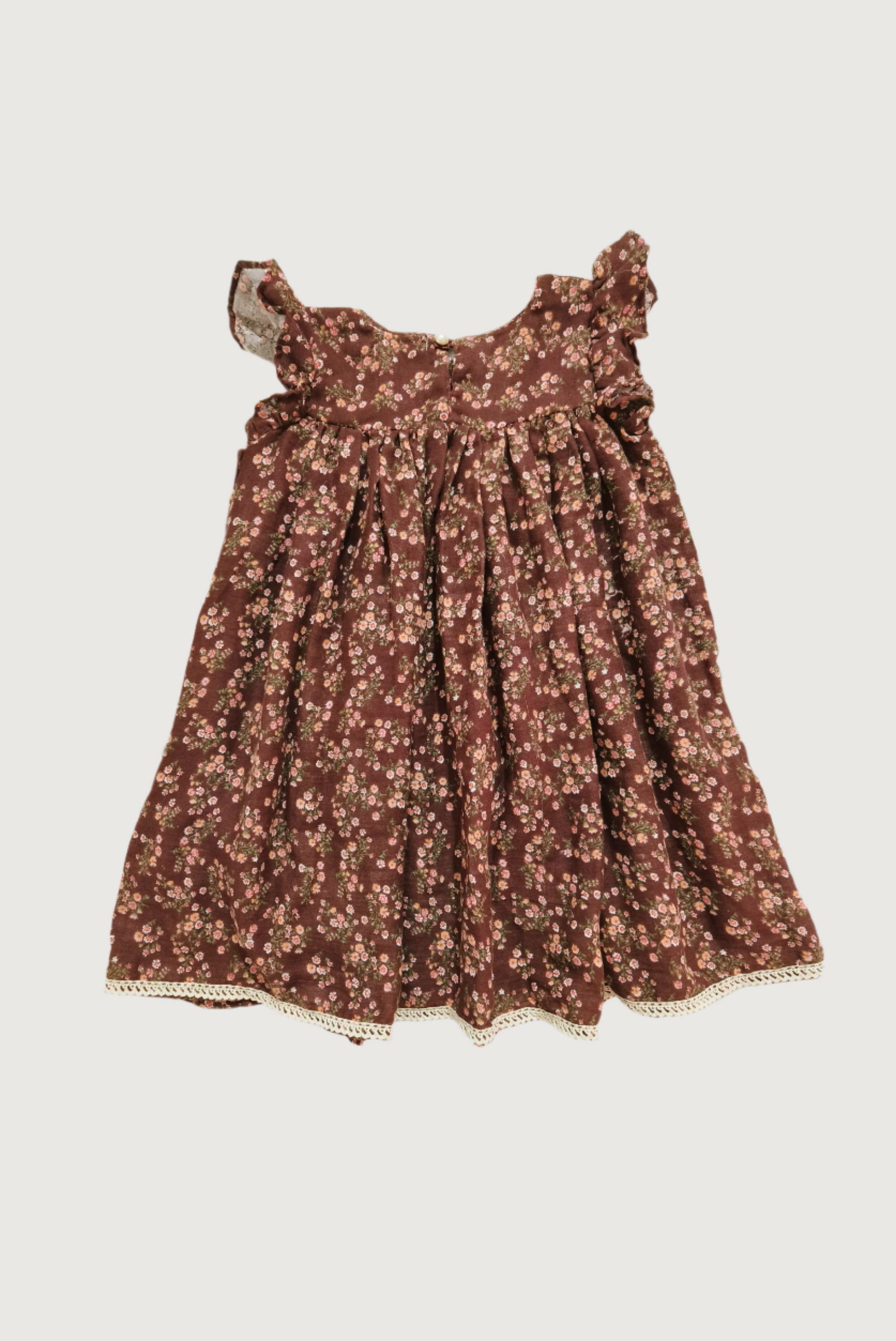 Back view of brown floral dress showing button closure and overall silhouette