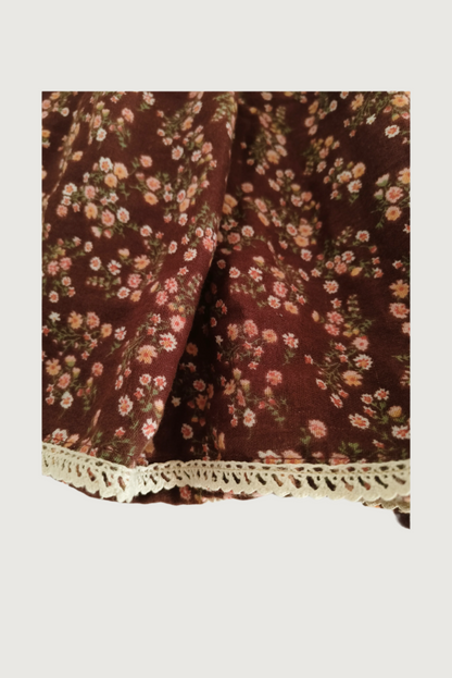 Close up of brown floral print poly cotton fabric and flutter sleeve construction detail
