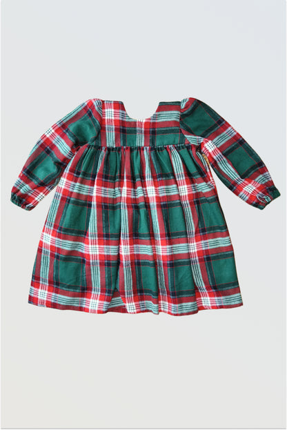 Back view of red green checkered winter dress showing single hook closure and gathered pleats