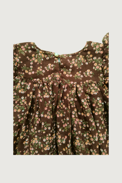 Close up of handcrafted crochet lace trim on brown floral dress empire waist