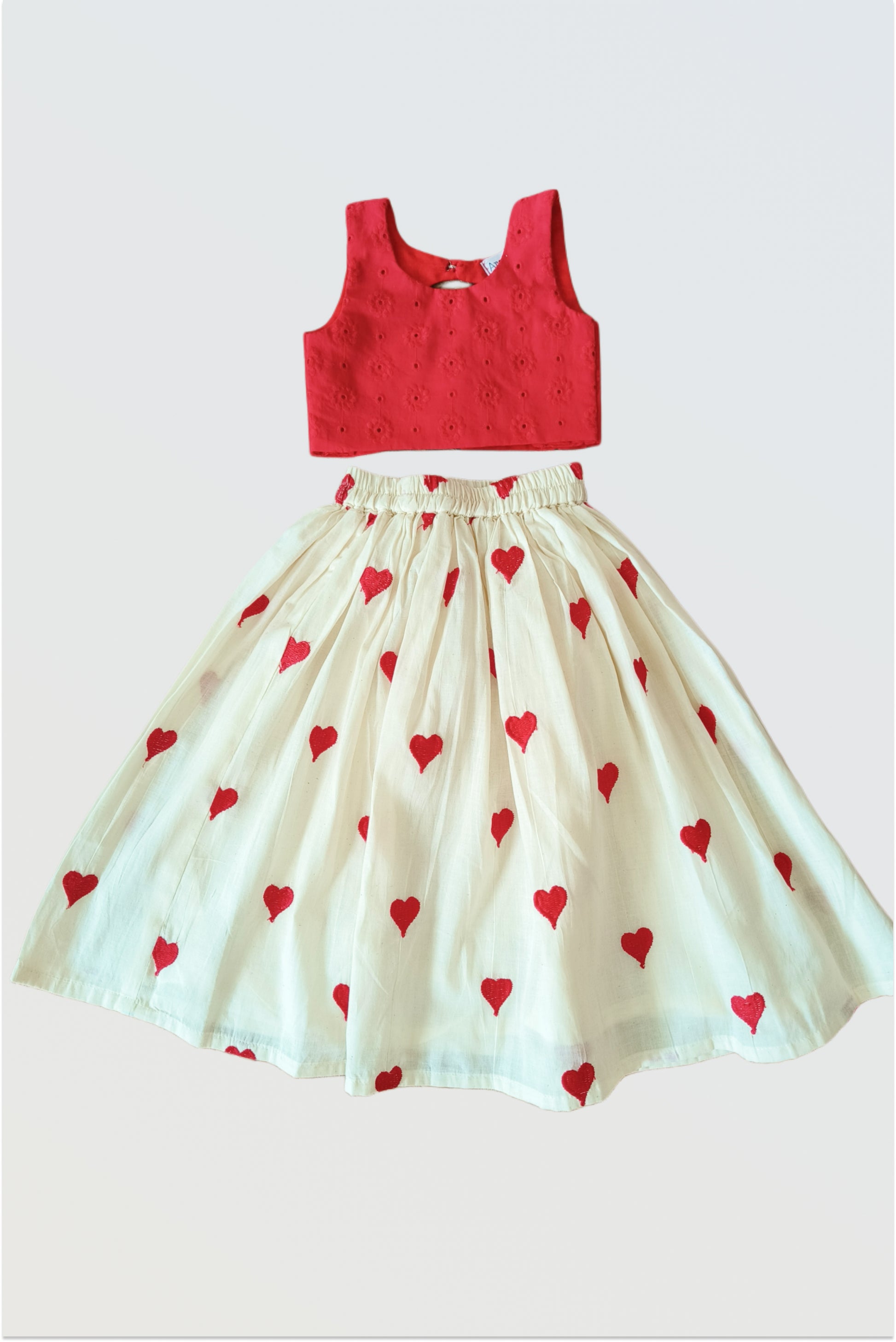 Dil Se lehanga set flat lay showing red hakoba choli and off-white heart embroidered skirt