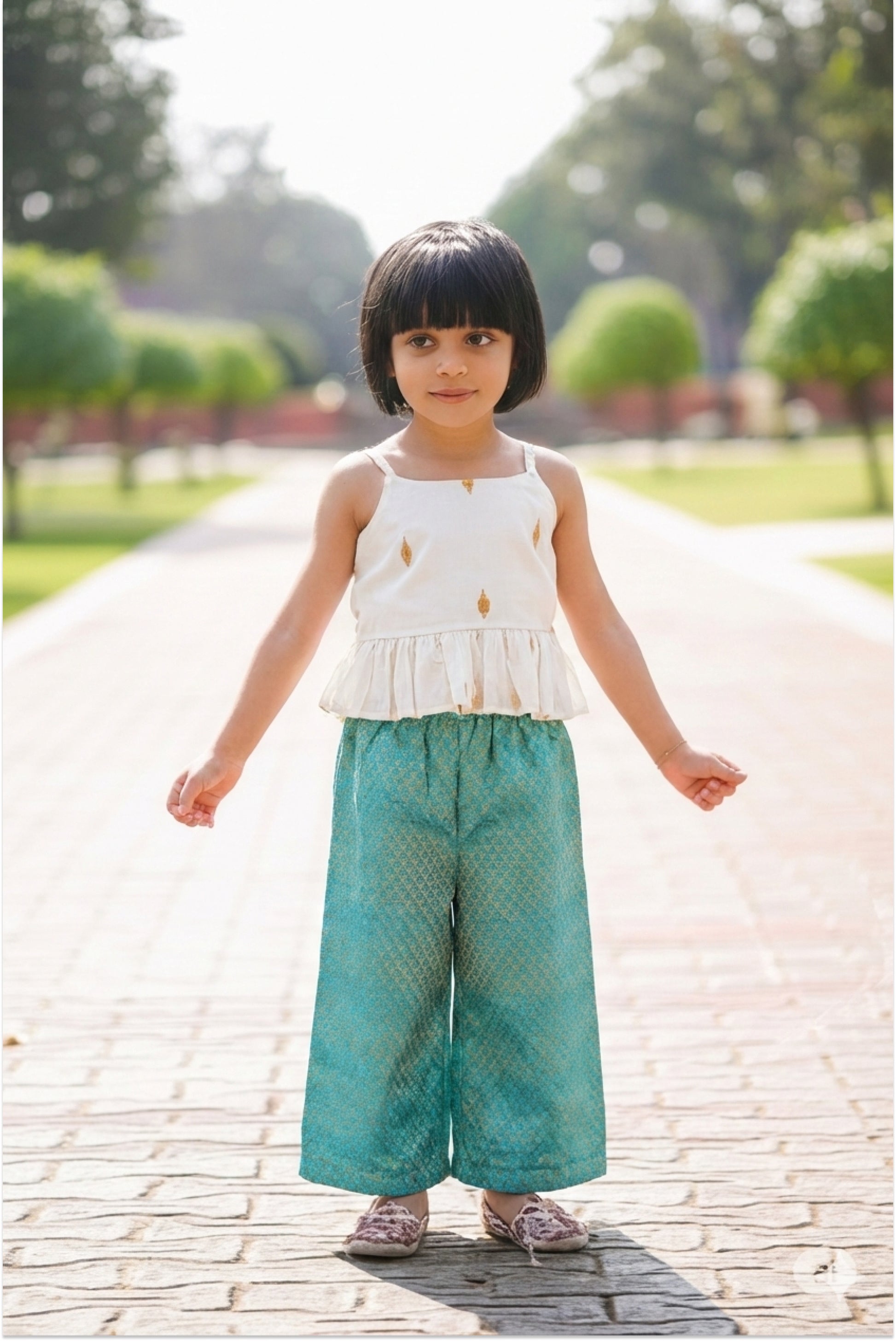 Girl wearing brocade palazzo set with Kerala kasavu peplum top and teal pants - Indo-Western ethnic wear