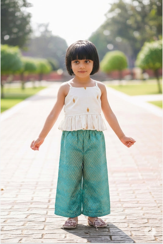 Girl wearing brocade palazzo set with Kerala kasavu peplum top and teal pants - Indo-Western ethnic wear