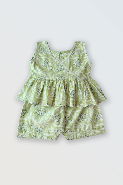 Girls summer co-ord set flat lay showing green ruffled top with lace and matching shorts