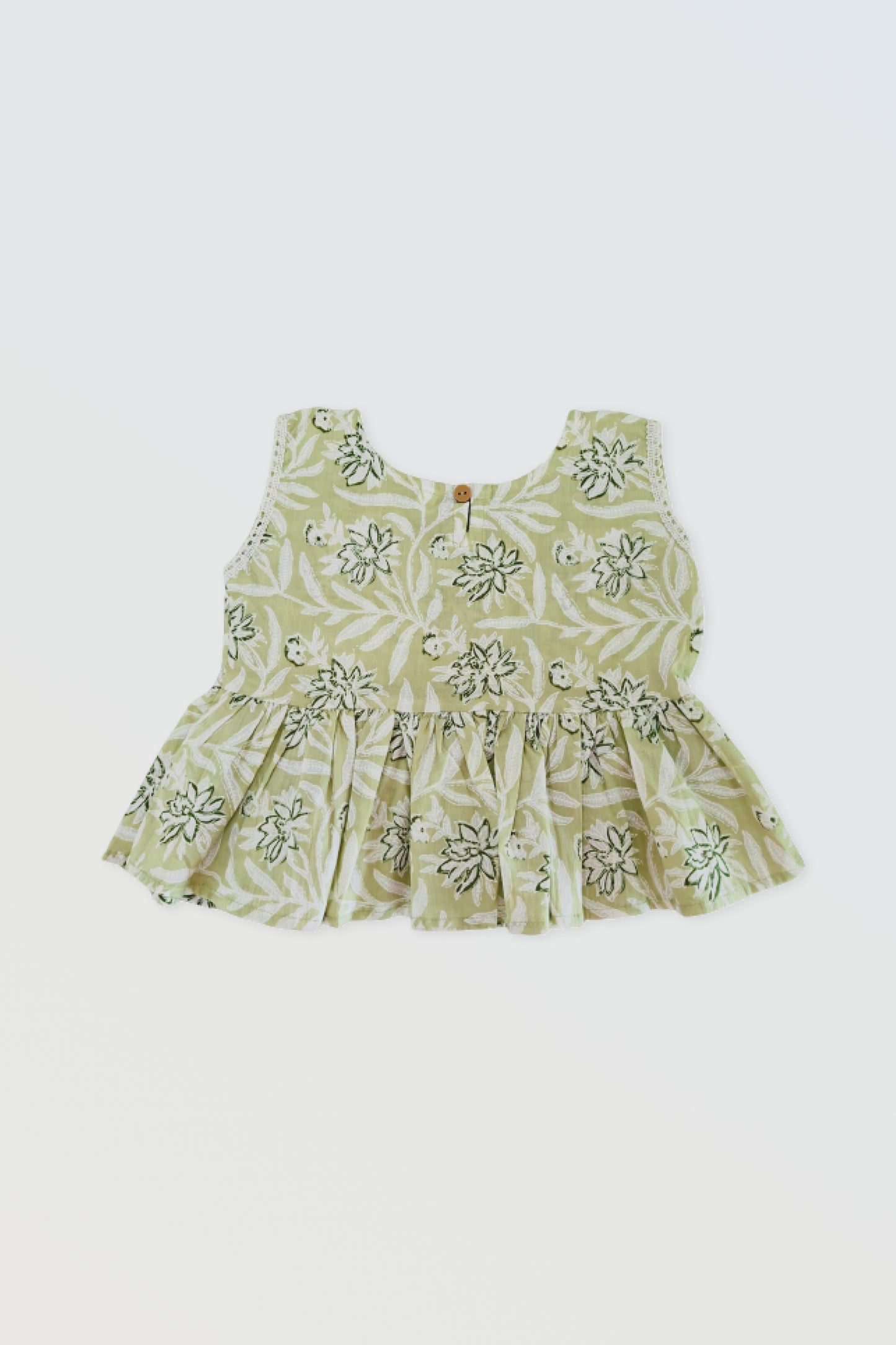 Back view of green ruffled top showing button closure and ruffle detail