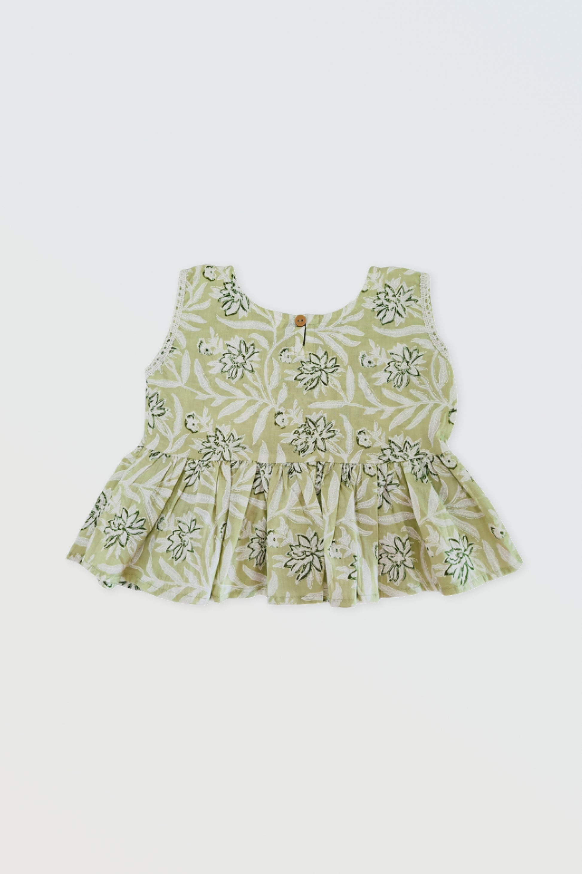 Back view of green ruffled top showing button closure and ruffle detail