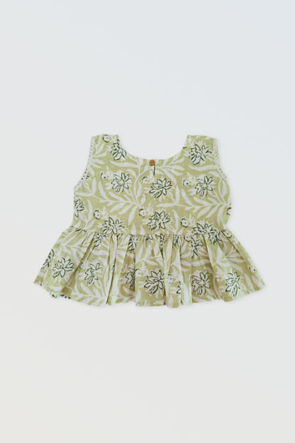 Back view of green ruffled top showing button closure and ruffle detail