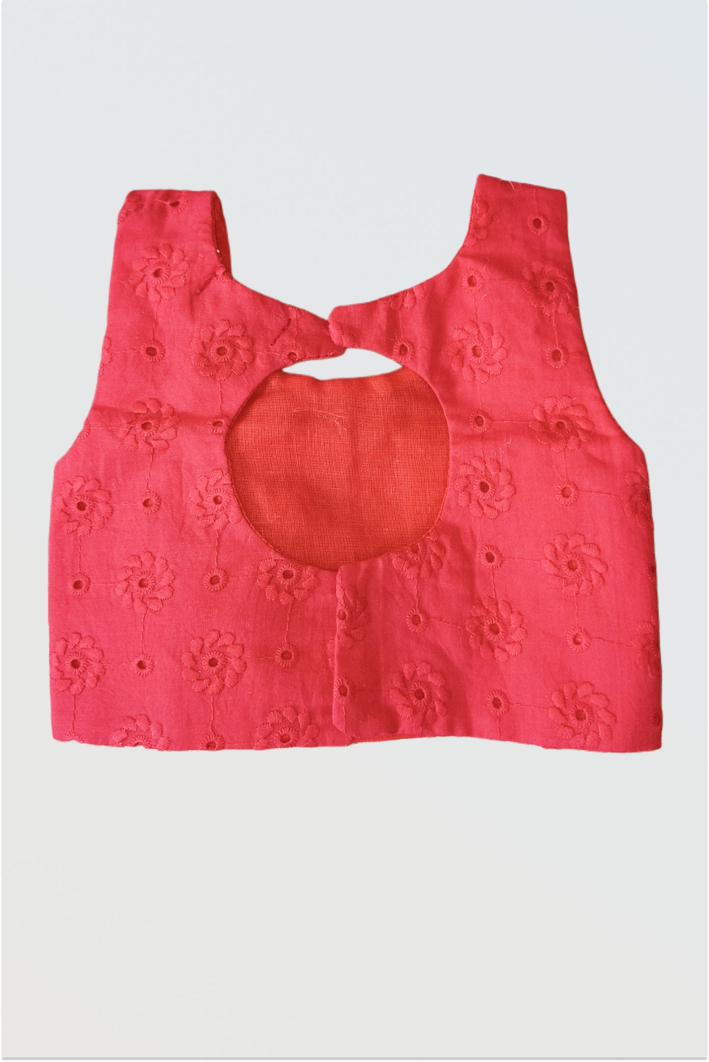 Back view of red hakoba choli showing modern cut-out detail and hook closure