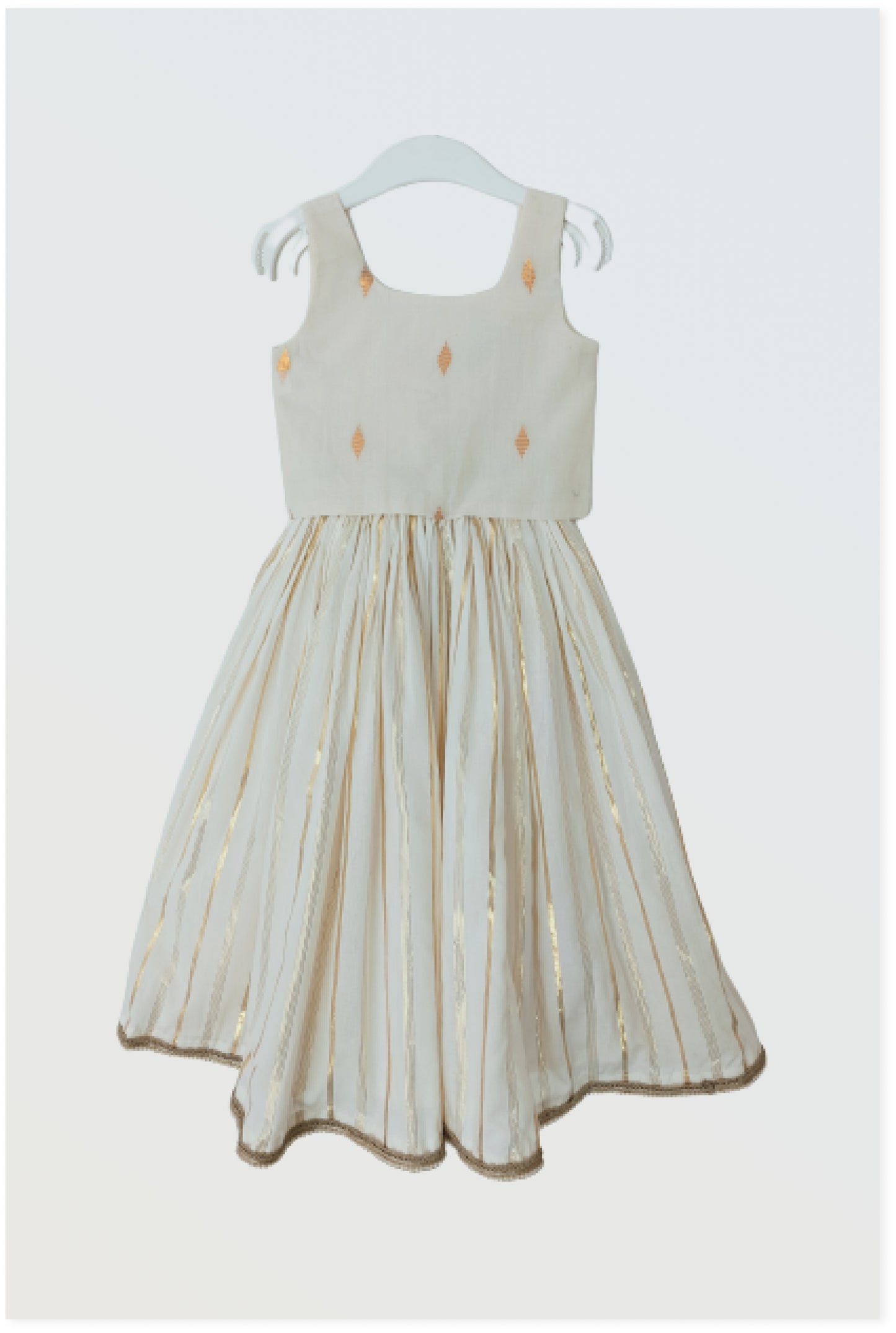 Kasavu Kerala lehanga set flat lay showing off-white cotton with golden lurex stripes and bow detail