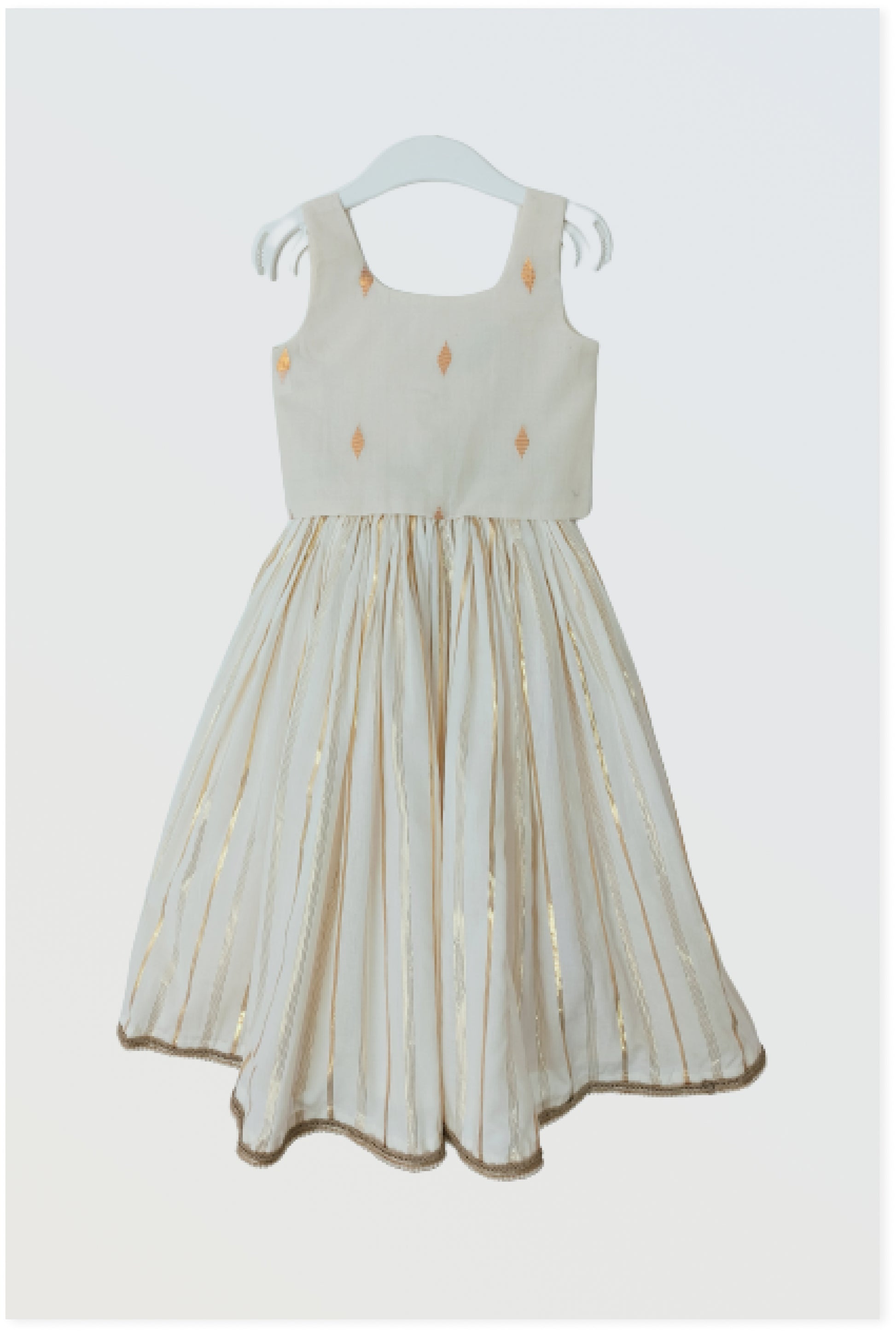 Kasavu Kerala lehanga set flat lay showing off-white cotton with golden lurex stripes and bow detail