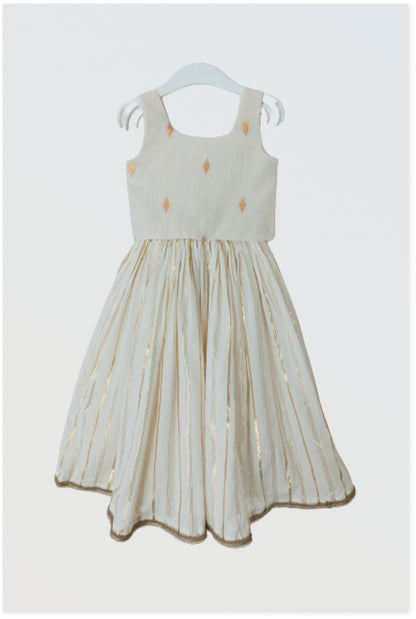 Kasavu Kerala lehanga set flat lay showing off-white cotton with golden lurex stripes and bow detail