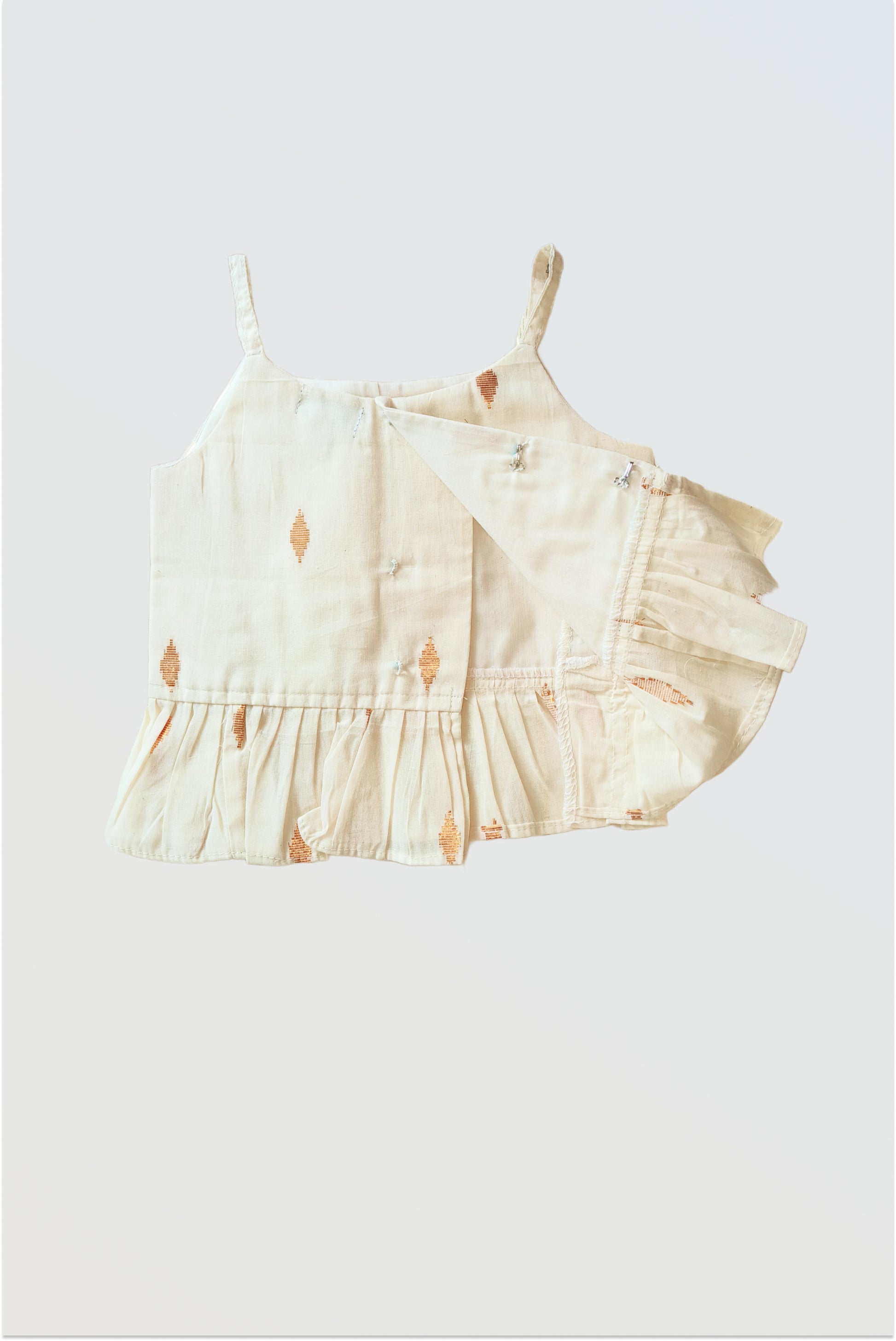 Close up of Kerala kasavu peplum top with golden lurex stripes and frilled hem detail