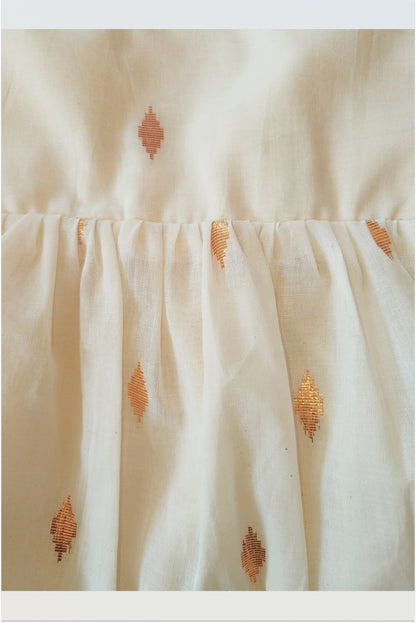 Close up of kasavu tie-up frock showing golden lurex stripes and pure cotton fabric detail