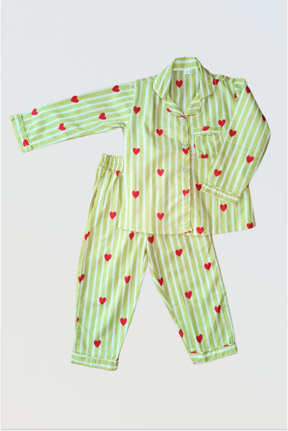 Kids Christmas pyjama set with green stripes and red hearts print - cotton nightwear flat lay