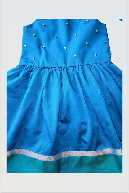 Close up of kundan stone embellishment work on traditional silk baby frock