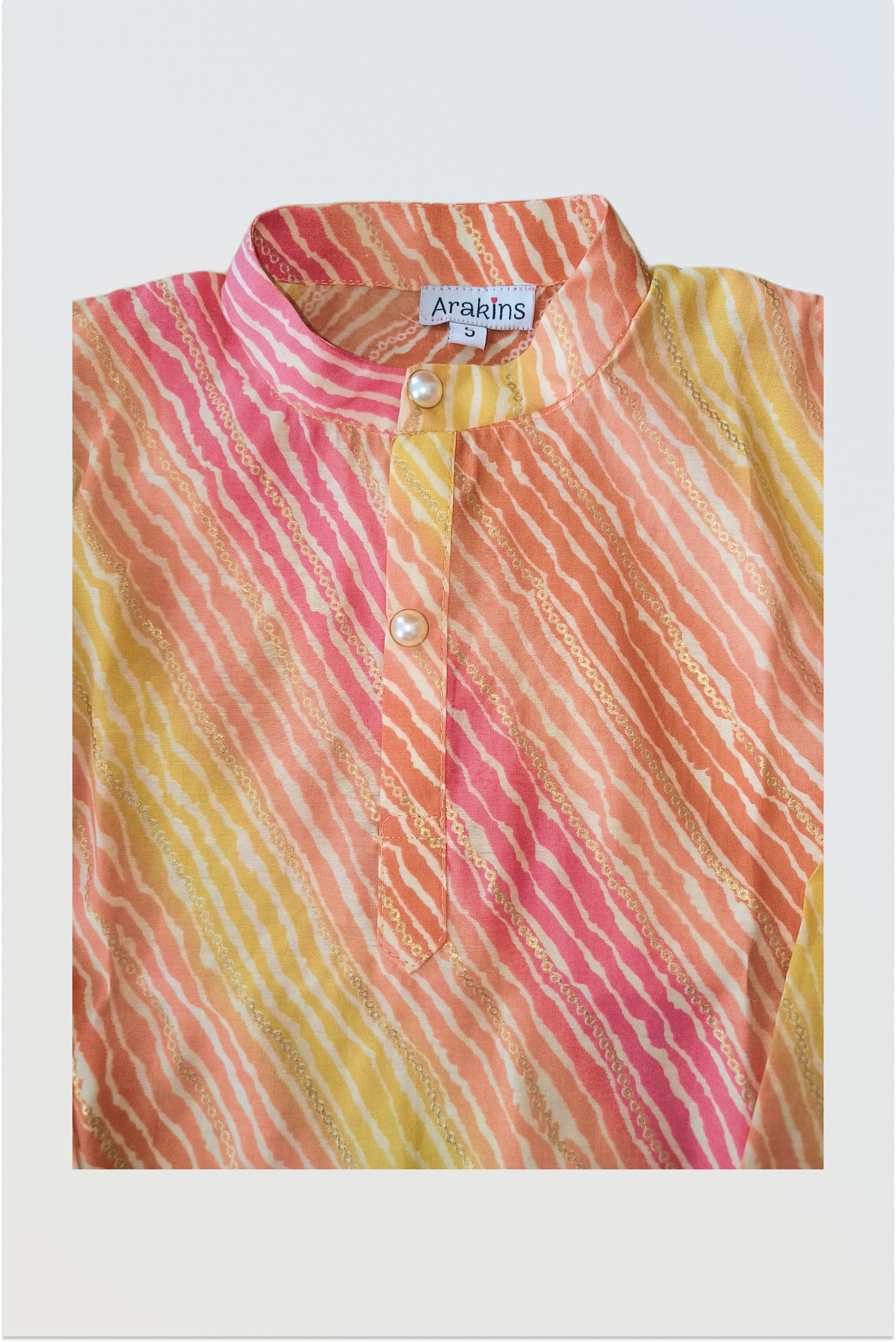 Close up of traditional lehariya pattern with golden foil print detail on kurta