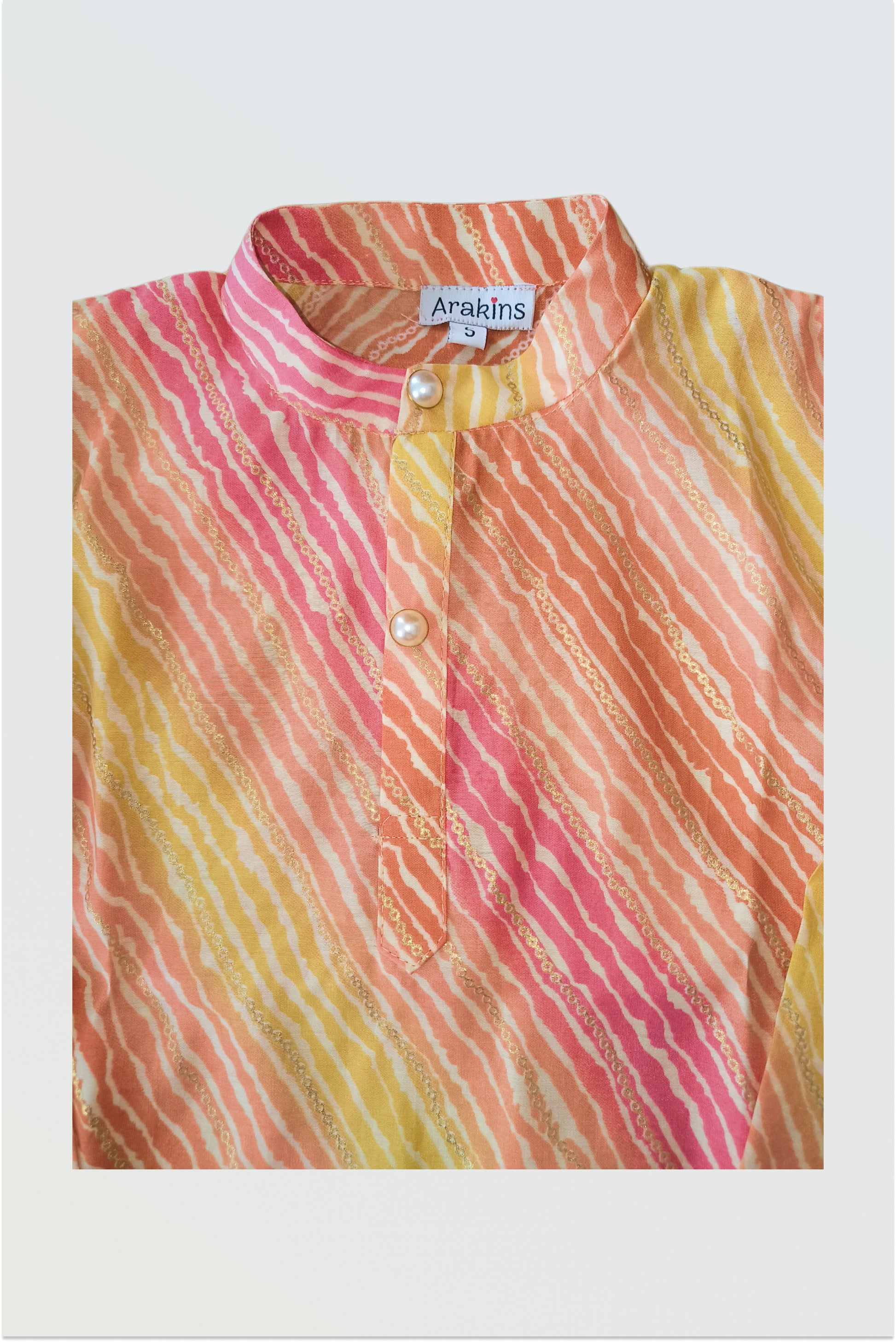 Close up of traditional lehariya pattern with golden foil print detail on kurta