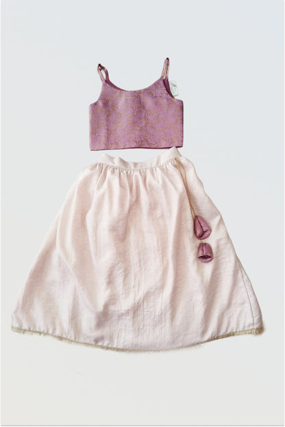 Pink brocade lehanga set flat lay showing lilac purple choli and soft blush pink skirt