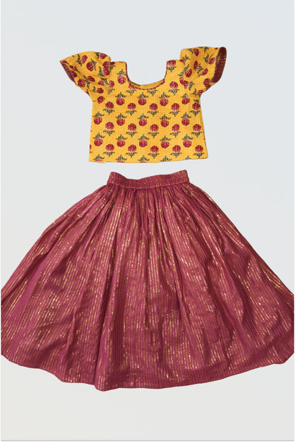 Yellow and maroon lehanga choli set flat lay showing block print top and maroon skirt