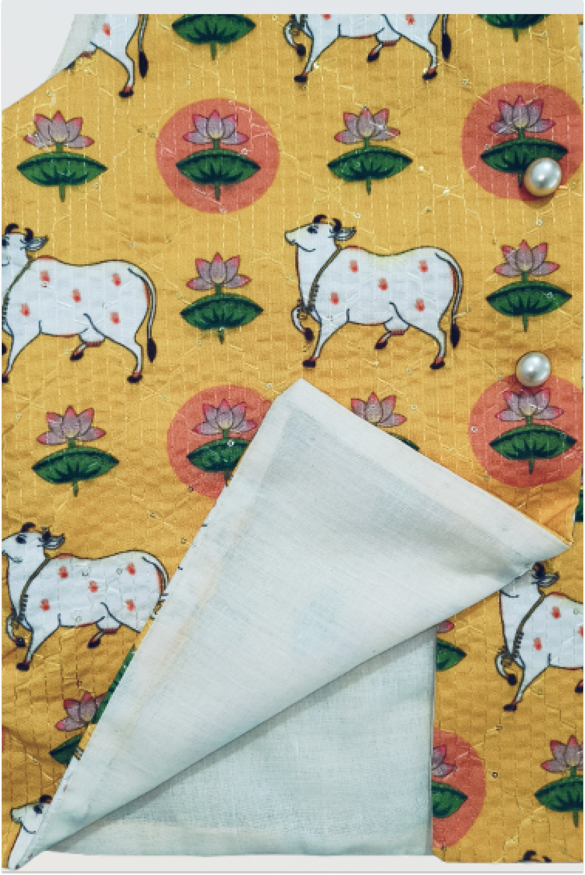 Close up of pichwai print jacket showing kantha embroidery and sequin detail