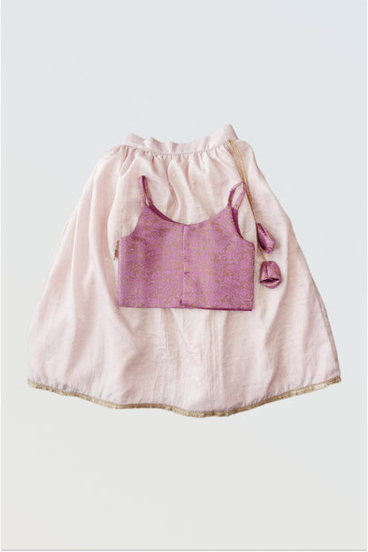 Back view of pink brocade lehanga set showing tassel tie-up details and full outfit