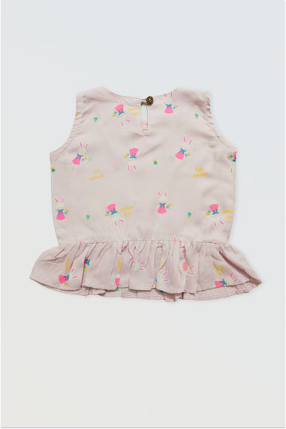 Back view of pink ruffle top showing button closure detail