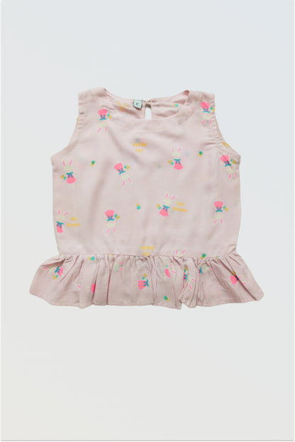 Pink ruffle top front view showing feminine ruffle detail and button back closure