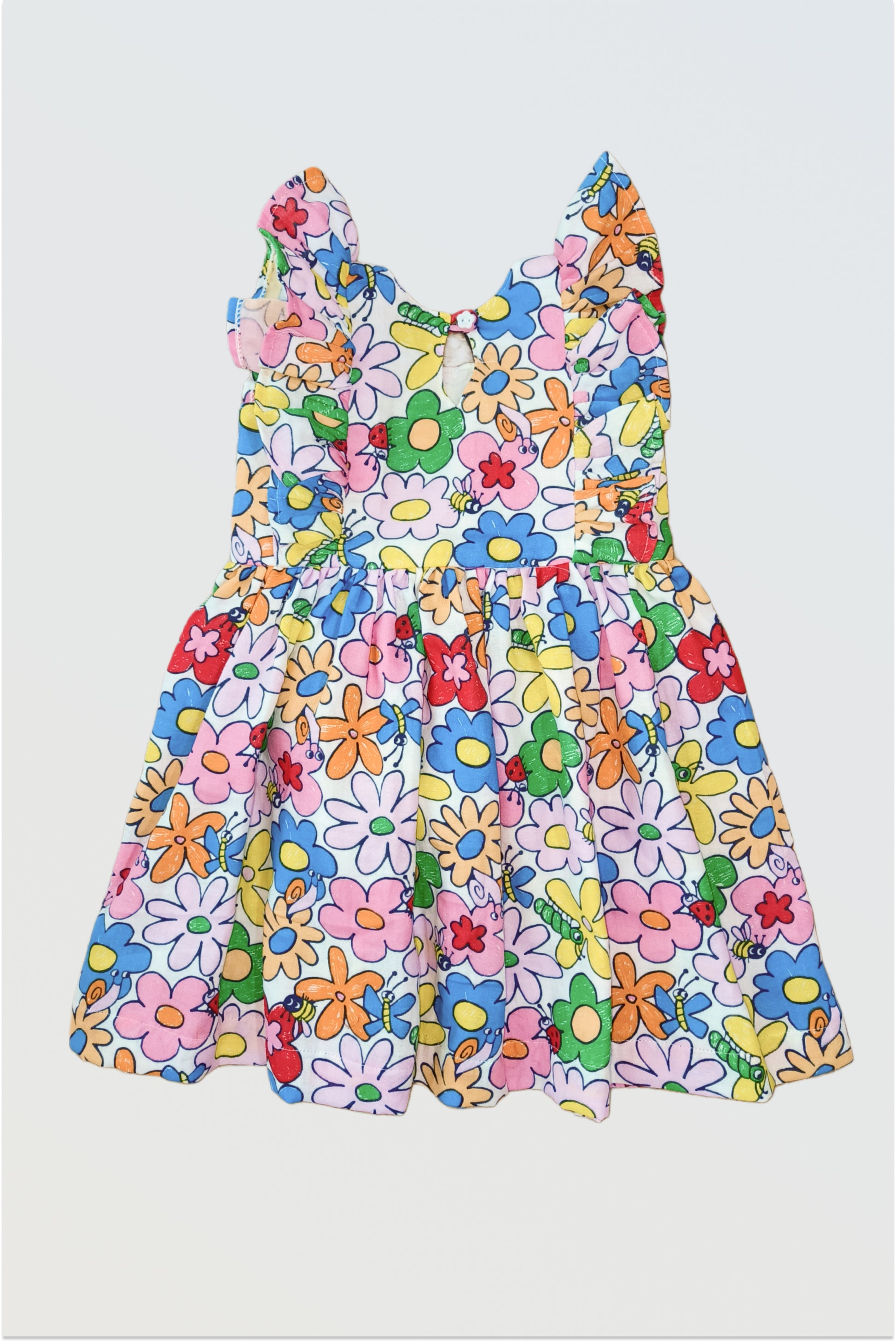 Back view of rainbow petals dress showing flutter cap sleeves and button closure detail
