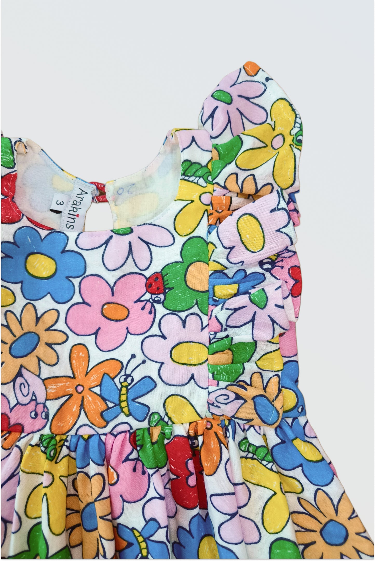 Close up of rainbow petals botanical floral print on cotton double cloth showing pink yellow brown peach flowers