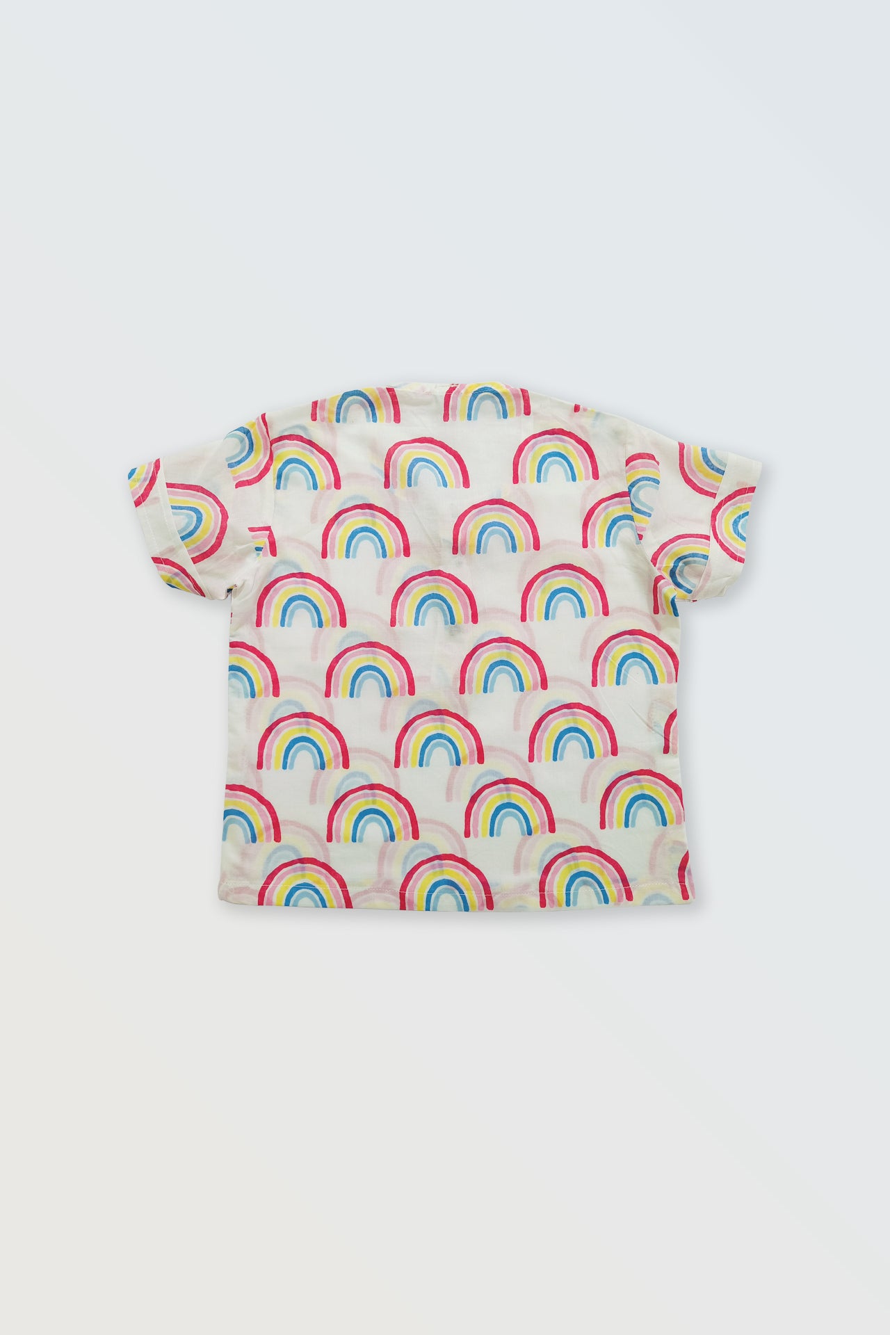 Back view of rainbow striped kids shirt showing colorful summer pattern