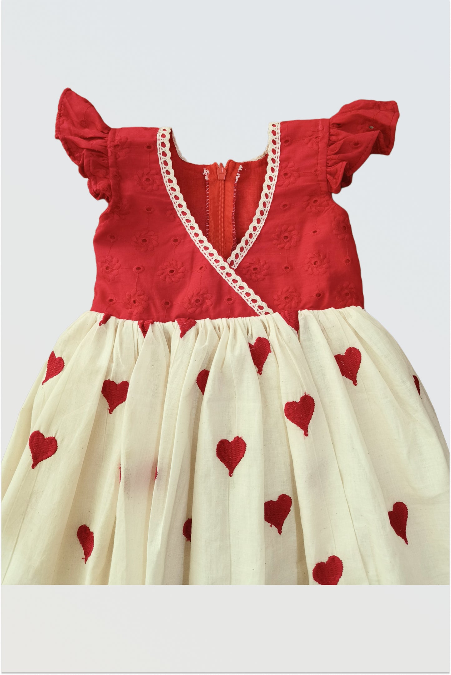 Close up detail of red hearts print on girls cotton dress