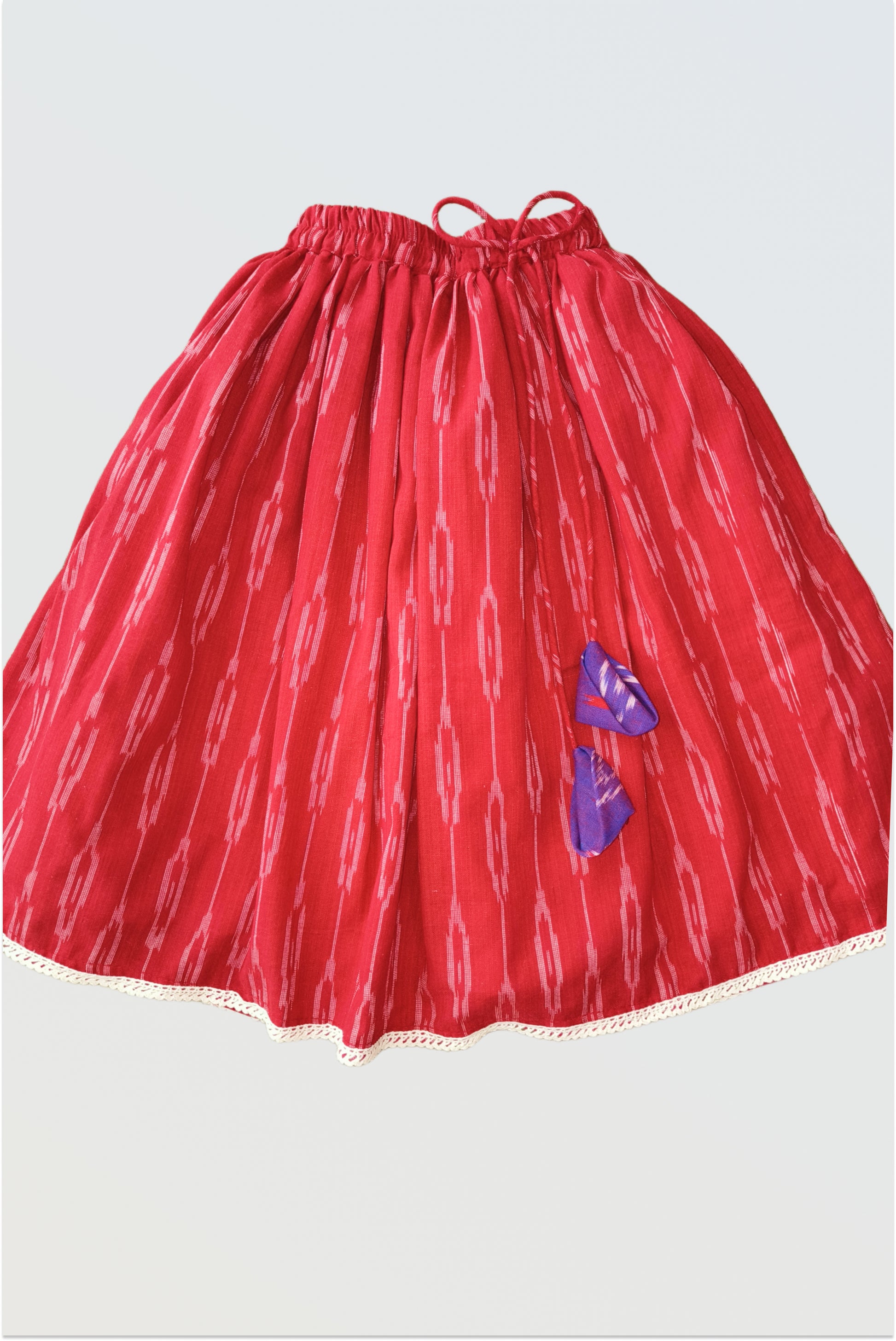 Red cotton lehanga skirt with decorative tassels and crocheted lace hem detail