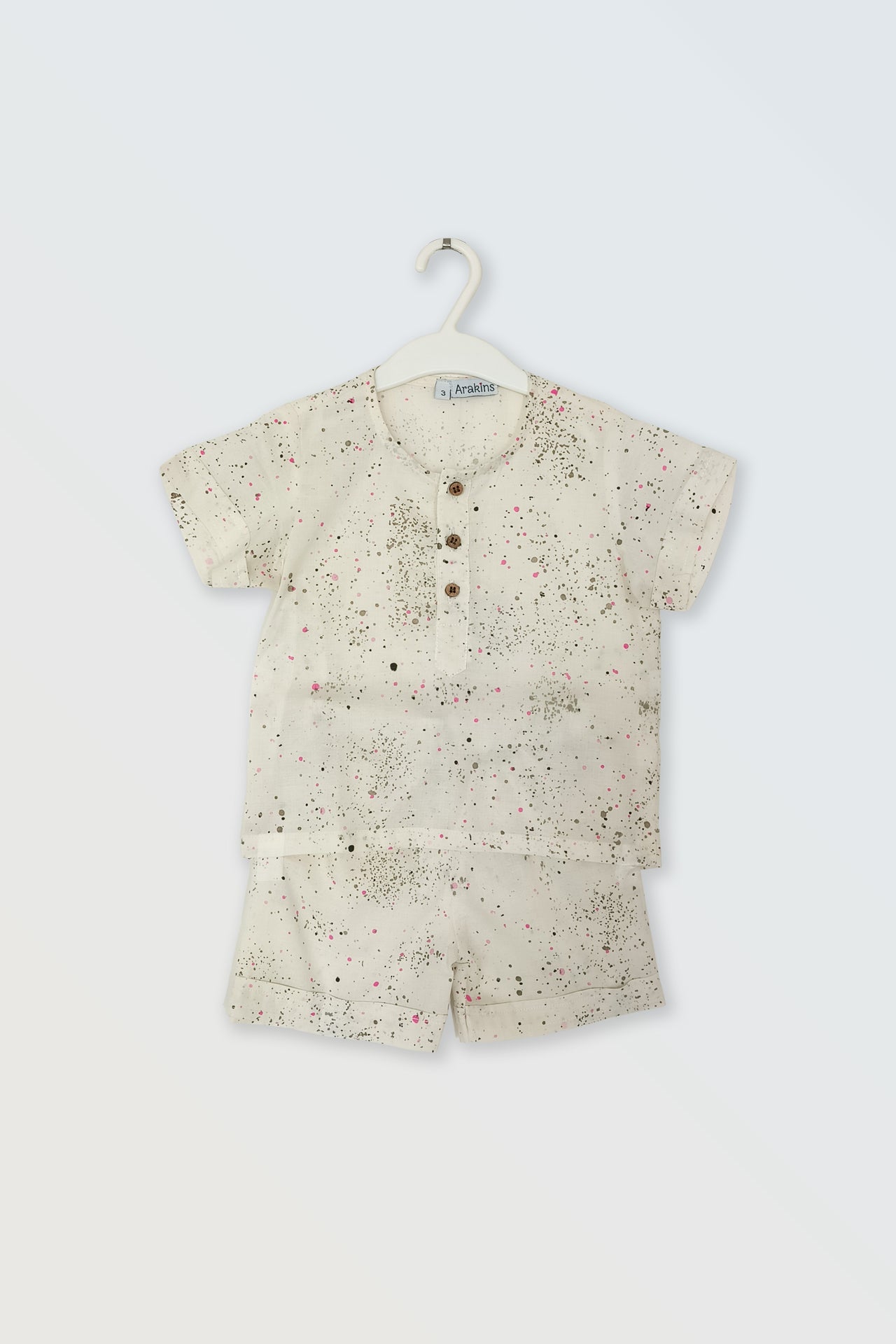 Unisex paint dots co-ord set flat lay showing cotton shirt and shorts for kids