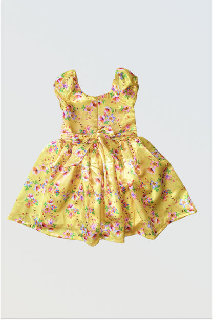 Back view of yellow satin dress showing zip closure and decorative tie-up belt detail